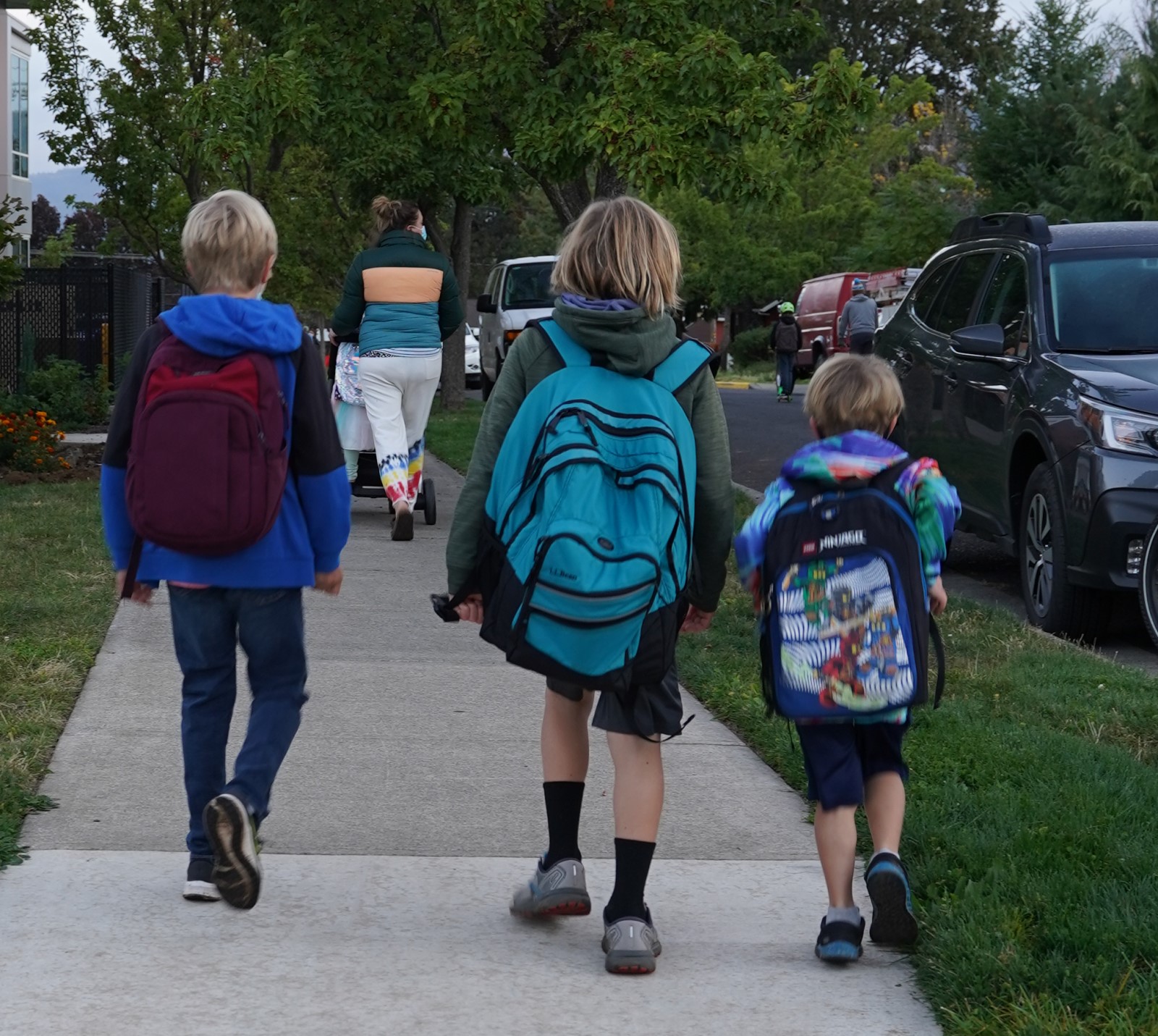 Neighbors walking along a calm street in the Hood River Heights